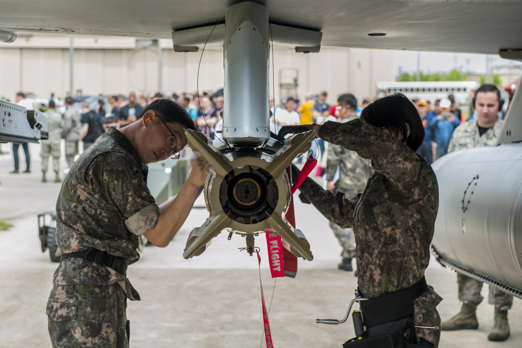 Republic of Korea Air Force airmen secure a bomb to an F-16 Fighting Falcon during the 2017 annual weapons load crew competition at Kunsan Air Base, Republic of Korea, May 13, 2017. Kunsan hosted the 2017 annual weapons load crew competition, which included members from the 35th Aircraft Maintenance Unit, 80th AMU, and 38th Fighter Group, Republic of Korea Air Force, located here, the 25th and 36th AMUs, from Osan Air Base, and the 14th AMU, from Misawa Air Base. (U.S. Air Force photo by Senior Airman Colville McFee/Released)  