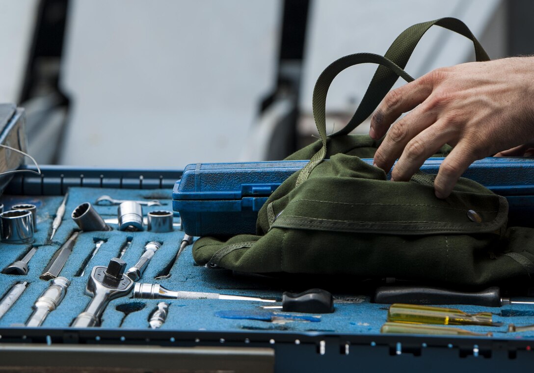 U.S. Air Force Staff Sgt. Dylan Ducharme, 80th Aircraft Maintenance Unit weapons load crew member, reaches for a tool during the 2017 annual weapons load crew competition at Kunsan Air Base, Republic of Korea, May 13, 2017. The annual load competition tests objectives like safety, speed, and cleanliness to enhance PACAF’s and ROKAF’s mission of always being ready to fight tonight.  (U.S. Air Force photo by Senior Airman Colville McFee/Released)  