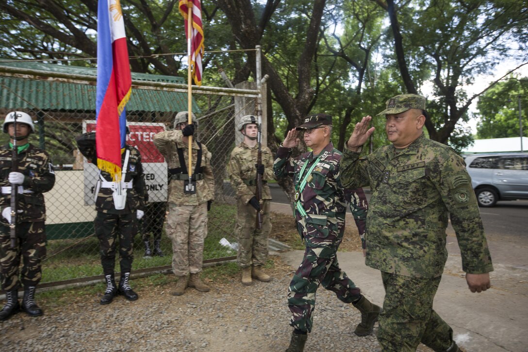 A Philippine and U.S. combined color guard greet Philippine Army Maj. Gen. Angelito De Leon, left, and Col. Laurence Mina during the opening ceremony of Balikatan 2017 at Fort Magsaysay in Santa Rosa, Nueva Ecija, May 8, 2017. De Leon is the commander of 7th Infantry Division and Mina is Deputy Assistant Chief of Staff for Training and Education Staff, Philippine Army. Balikatan is an annual U.S.-Philippine bilateral military exercise focused on a variety of missions including humanitarian and disaster relief, counterterrorism, and other combined military operations.