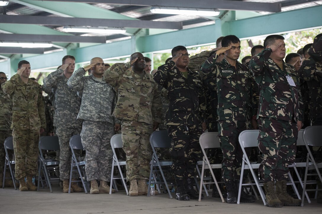 Philippine and U.S. service members render salutes during the opening ceremony of Balikatan 2017 at Fort Magsaysay in Santa Rosa, Nueva Ecija, May 4, 2017. Balikatan is an annual U.S.-Philippine bilateral military exercise focused on a variety of missions including humanitarian and disaster relief, counterterrorism, and other combined military operations.