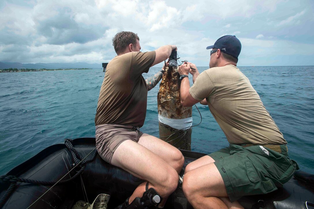 U.S. Navy Steelworker 2nd Class Tyler Ault and Construction Mechanic 1st Class Jeff Snider, Underwater Construction Team 2, prepare a radio-frequency receiver during an underwater construction demolition dive in support of Balikatan 2017 at Ipil Port in Ormoc City, Leyte, May 10, 2017. The demolition training prepares the U.S. military and Armed Forces of the Philippines to clear debris in ports and open up supply lines for victims of natural disasters and crises. Underwater demolition can help Philippine and U.S. forces provide humanitarian assistance and disaster relief operations from the sea to remote areas of the Philippines. 