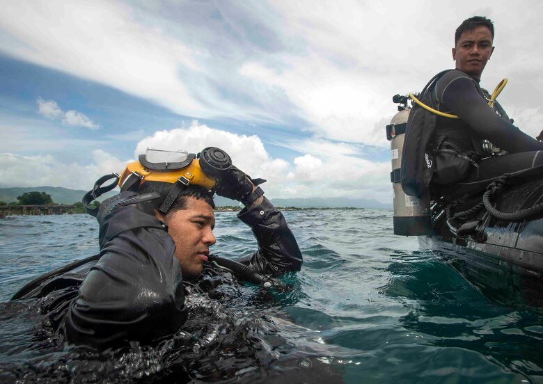 U.S. Navy Utilitiesman 2nd Class Eric Martin, Underwater Construction Team, prepares to dive during an underwater construction demolition dive in support of Balikatan 2017 at Ipil Port in Ormoc City, Leyte, May 10, 2017. The demolition training prepares the U.S. military and Armed Forces of the Philippines to clear debris in ports and open up supply lines for victims of natural disasters and crises. Underwater demolition can help Philippine and U.S. forces provide humanitarian assistance and disaster relief operations from the sea to remote areas of the Philippines. 