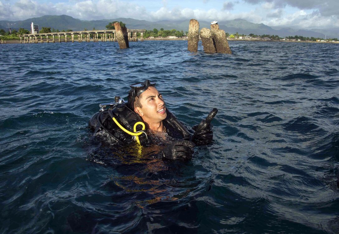 U.S. Navy Equipment Operator 3rd Class Thomas Dalhke, Underwater Construction Team 2, prepares to dive during an underwater construction demolition dive in support of Balikatan 2017 at Ipil Port in Ormoc City, Leyte, May 10, 2017. The demolition training prepares the U.S. military and Armed Forces of the Philippines to clear debris in ports and open up supply lines for victims of natural disasters and crises. Underwater demolition can help Philippine and U.S. forces provide humanitarian assistance and disaster relief operations from the sea to remote and austere areas of the Philippines.