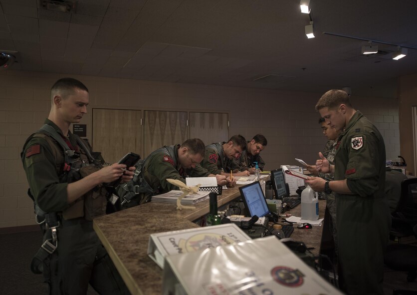 U.S. Air Force Capt. Benjamin Walters, far right, a 13th Fighter Squadron pilot from Misawa Air Base, Japan, briefs other pilots prior to stepping during Northern Edge 2017 at Eielson Air Force Base, Alaska, May 11, 2017. NE17 is the largest military training exercise scheduled in Alaska this year with virtual and constructive participants from all over the U.S. exercising alongside live players. (U.S. Air Force photo by Tech. Sgt. Araceli Alarcon)