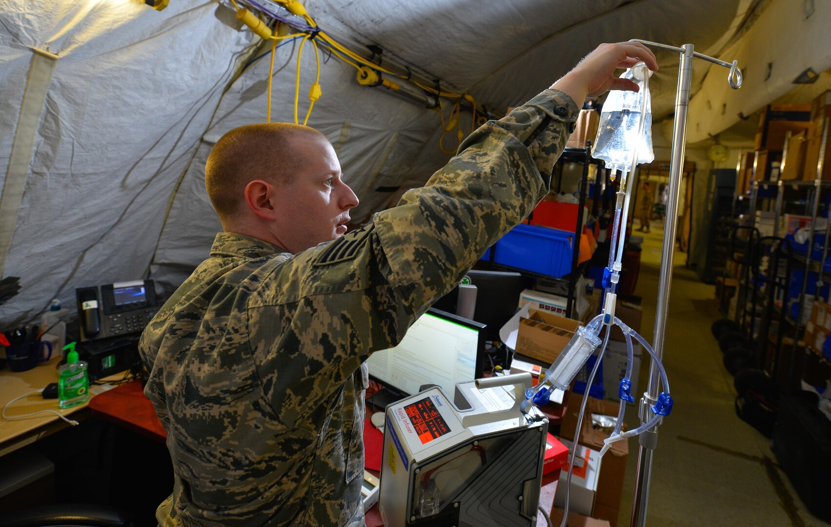 Staff Sgt. Ryan McGinniss, a biomedical equipment technician with the 332nd Expeditionary Medical Group, pours water into an infusion bag while testing a blood infusion pump unit May 9, 2017, in Southwest Asia. McGinnis is the only biomedical equipment technician for the last Expeditionary Medical Support System installation  supporting joint and coalition members deployed to Operation Inherent Resolve. (U.S. Air Force photo by Staff Sgt. Alexander W. Riedel)