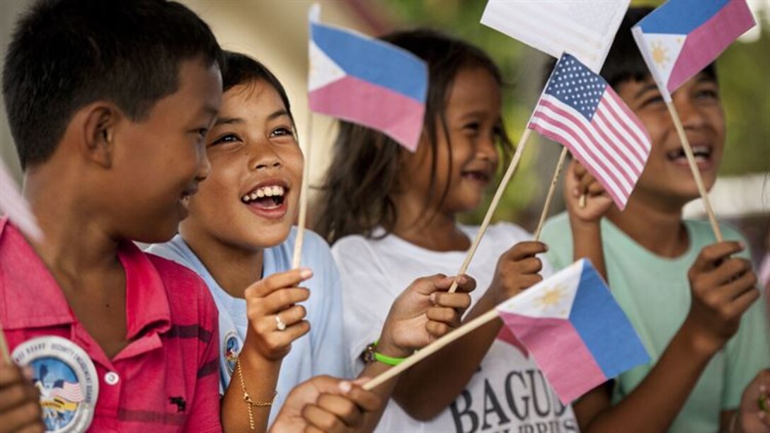 Filipino children wave U.S. and Philippine flags during a groundbreaking ceremony for Balikatan 2017 in Ormoc City, Leyte, April 25, 2017. Leaders from the Armed Forces of the Philippines, U.S. military, and Ormoc City gathered to commemorate the beginning of engineering projects for new classrooms at Margen Elementary School in Ormoc City. Balikatan is an annual U.S.-Philippine military bilateral exercise focused on a variety of missions, including humanitarian assistance and disaster relief and counterterrorism.