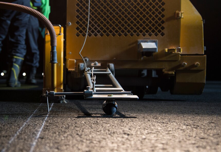 A concrete road cutting machine sits on the runway at Misawa Air Base, Japan, May 5, 2017. The machine was used to cut a line across the runway, allowing the more than 50 contracted Japanese nationals to tear up the flightline, which will be repaired during the next two months. (U.S. Air Force photo by Senior Airman Brittany A. Chase)