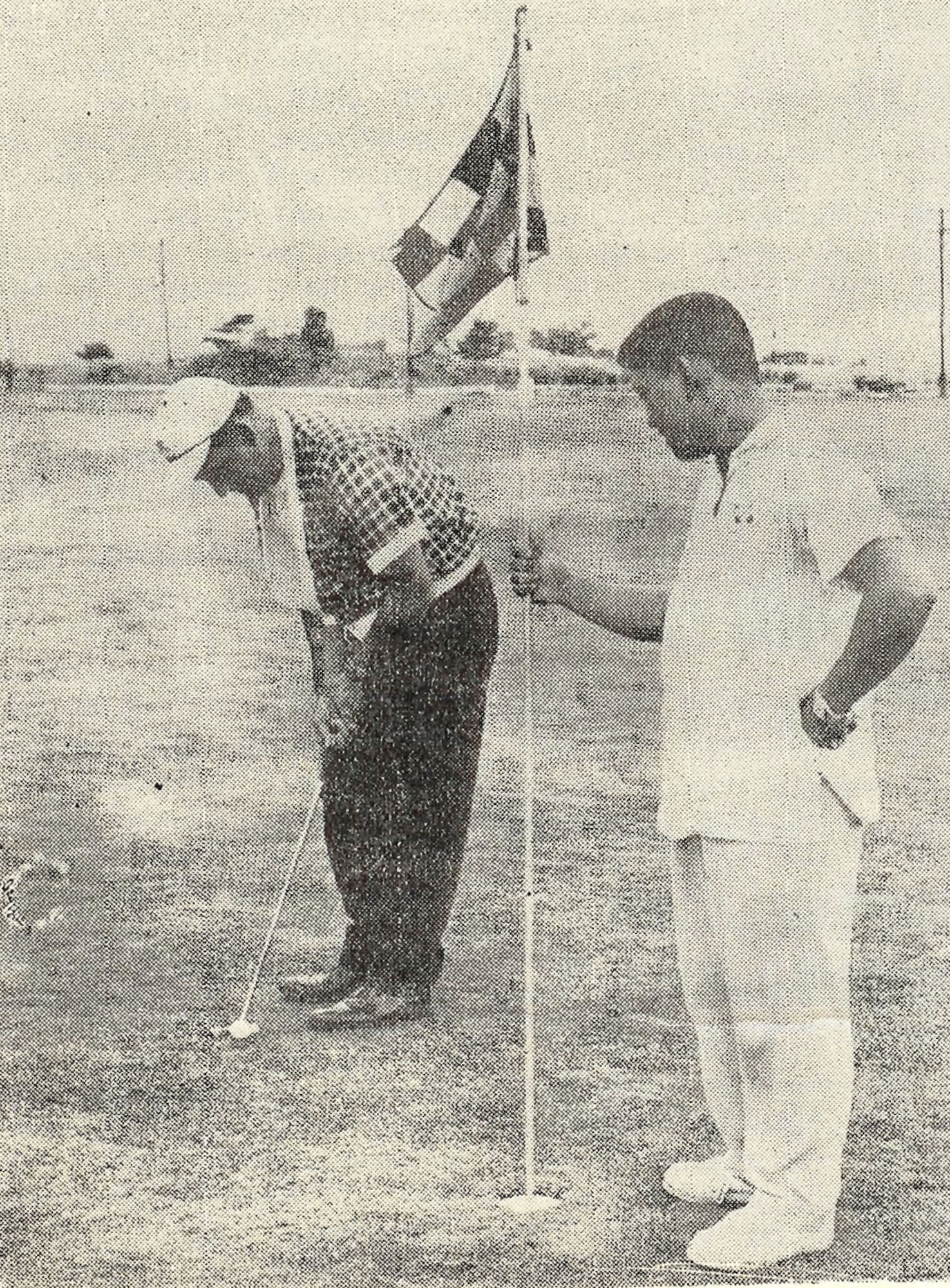 Tatsuo “Jimmy” Schwartz holds a flag for a golfer at Kadena Air Base, Japan. Shwartz has donated more than 3,300 trees to Kadena over the course of his more than 50 years of service to the U.S. military. (courtesy photo)