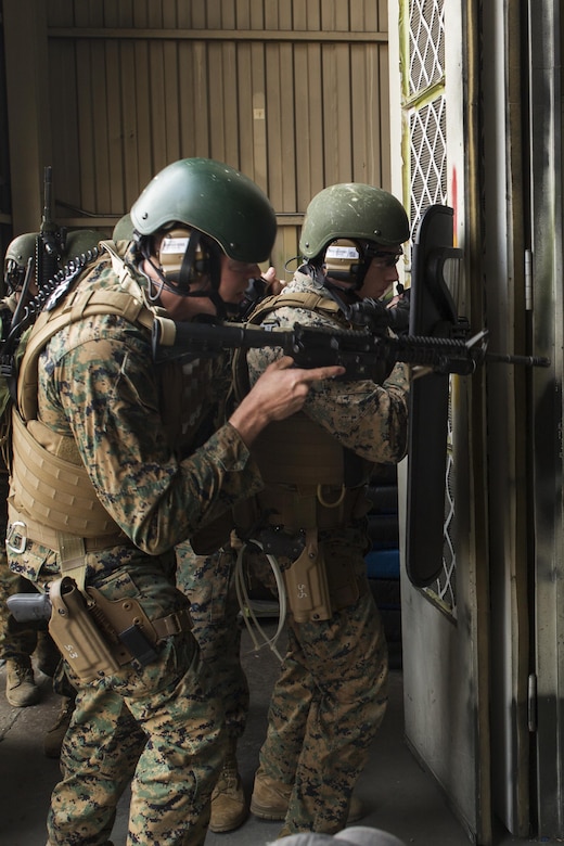 U.S. Marine Corps Lance Cpls. Jackson Stumb, left, and Benjamin Irish, right, Special Reaction Team (SRT) members for Marine Corps Air Station (MCAS) Iwakuni, conduct breaching techniques during cross training exercises with the Hiroshima and Yamaguchi Prefectural Police Headquarters at MCAS Iwakuni, Japan, March 28, 2017. Members with the Hiroshima and Yamaguchi Prefectural Police Headquarters traveled to the air station to observe SRT conduct high-risk training scenarios. The training ranged from room-clearing, breaching, communication and non-lethal take-down techniques. (U.S. Marine Corps photo by Lance Cpl. Joseph Abrego)