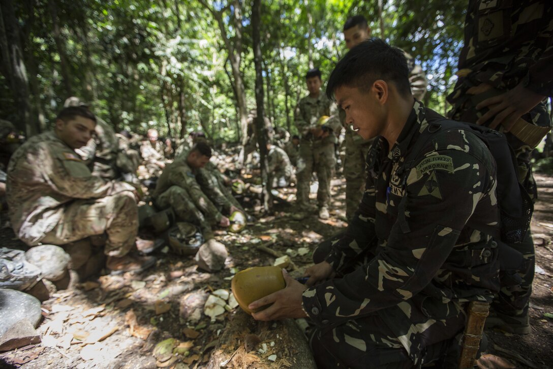 A Philippine Special Forces Soldier explains the nutritional value of a coconut in a jungle survival scenario to U.S. Soldiers, 1st Battalion, 23rd Infantry Regiment, during a subject matter expert exchange in support of Balikatan 2017 at Fort Magsaysay in Santa Rosa, Nueva Ecija, May 13, 2017. U.S. Soldiers trained with Philippine Special Forces to understand the Armed Forces of the Philippines’ techniques for operating in a jungle environment. Balikatan is an annual U.S.-Philippine bilateral military exercise focused on a variety of missions, including humanitarian and disaster relief, counterterrorism, and other combined military operations. 