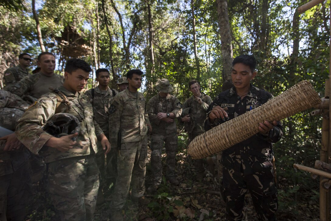 A Philippine Special Forces Soldier shows U.S. Soldiers, 1st Battalion, 23rd Infantry Regiment, a basket made from plant fibers during a subject matter expert exchange in support of Balikatan 2017 at Fort Magsaysay in Santa Rosa, Nueva Ecija, May 13, 2017. U.S. Soldiers trained with Philippine Special Forces to understand the Armed Forces of the Philippines’ techniques for operating in a jungle environment. Balikatan is an annual U.S.-Philippine bilateral military exercise focused on a variety of missions, including humanitarian and disaster relief, counterterrorism, and other combined military operations. 