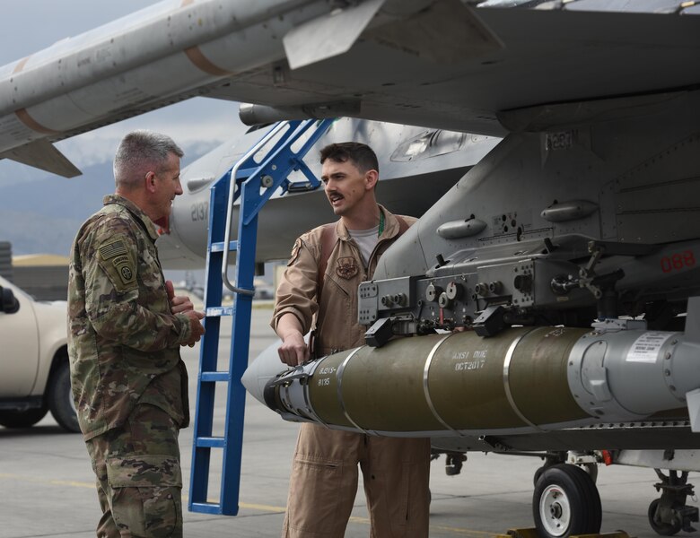 U.S. Army Gen. John Nicholson, commander of Resolute Support Mission and U.S. Forces Afghanistan, speaks with U.S. Air Force Maj. Greg Balzhiser, a 555th Expeditionary Fighter Squadron F-16 Fighting Falcon pilot, about the capabilities of the F-16 at Bagram Airfield, Afghanistan, May 13, 2017. During his visit, Nicholson spoke with Airmen from the 555th EFS about the F-16 and what it brings to the counterterrorism fight in Afghanistan. (U.S. Air Force photo by Staff Sgt. Benjamin Gonsier)