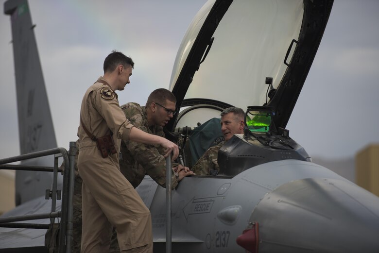 U.S. Army Gen. John Nicholson, commander of Resolute Support Mission and U.S. Forces Afghanistan, speaks with U.S. Air Force Maj. Greg Balzhiser, a 555th Expeditionary Fighter Squadron F-16 Fighting Falcon pilot, and Airman 1st Class Andrew Meier, a 455th Expeditionary Aircraft Maintenance Squadron avionics apprentice, at Bagram Airfield, Afghanistan, May 13, 2017. During his visit, Nicholson spoke with Airmen from the 555th EFS about the F-16 and what it brings to Afghanistan. Balzhiser and Meier are currently deployed out of Aviano Air Base, Italy. (U.S. Air Force photo by Staff Sgt. Benjamin Gonsier)