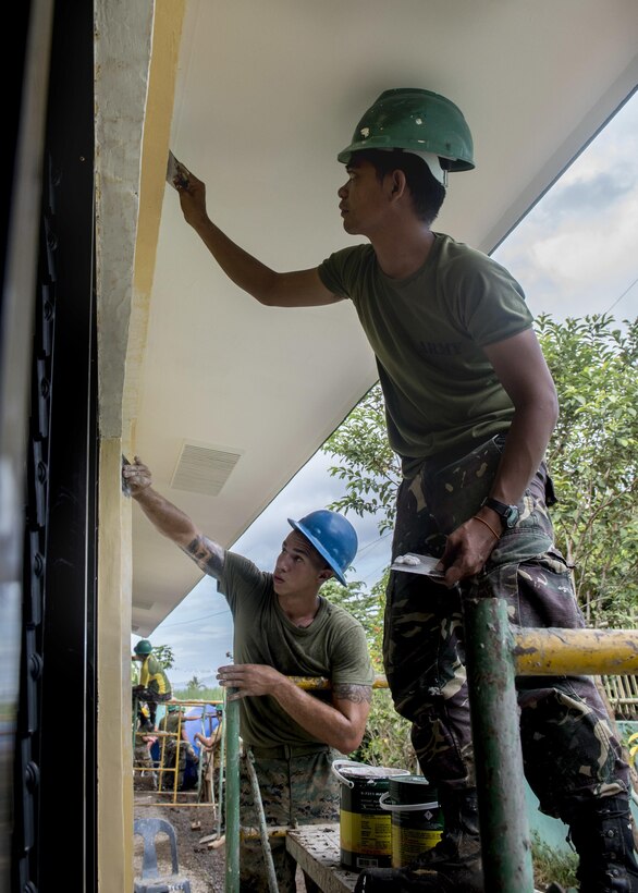 Philippine Army Pfc. Socrates Boyles, right, and U.S. Marine Cpl. Quentin Newton repair walls during an engineering civic assistance project in support of Balikatan 2017 in Ormoc City, Leyte, May 12, 2017. Philippine and U.S. service members worked together to build new classrooms for students at Don Carlos Elementary School. Balikatan is an annual U.S.-Philippine bilateral military exercise focused on a variety of missions, including humanitarian assistance and disaster relief, counterterrorism, and other combined military operations. 