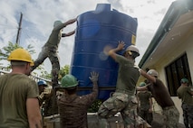 Philippine and U.S. service members install a water storage tank during an engineering civic assistance project in support of Balikatan 2017 in Ormoc City, Leyte, May 12, 2017. Philippine and U.S. service members worked together to build new classrooms for students at Don Carlos Elementary School. Balikatan is an annual U.S.-Philippine bilateral military exercise focused on a variety of missions, including humanitarian assistance and disaster relief, counterterrorism, and other combined military operations. 