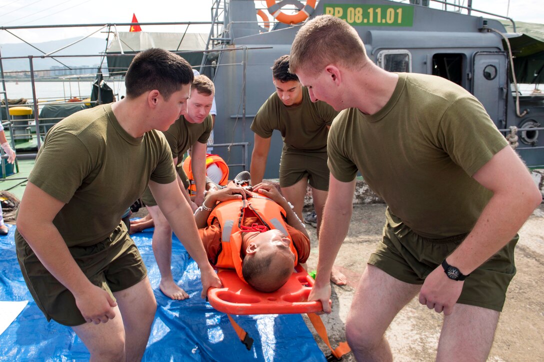 U.S. Marines and Vietnamese emergency responders carry a mock casualty to receive medical care while participating in a search, rescue and oil spill response field training exercise during Pacific Partnership 2017 in Da Nang, Vietnam, May 13, 2017. The Marines are assigned to the 9th Engineer Support Battalion. Pacific Partnership is the largest annual multilateral humanitarian assistance and disaster relief preparedness mission conducted in the Indo-Asia-Pacific and aims to enhance regional coordination in areas such as medical readiness and preparedness for manmade and natural disasters. Navy photo by Petty Officer 2nd Class Joshua Fulton