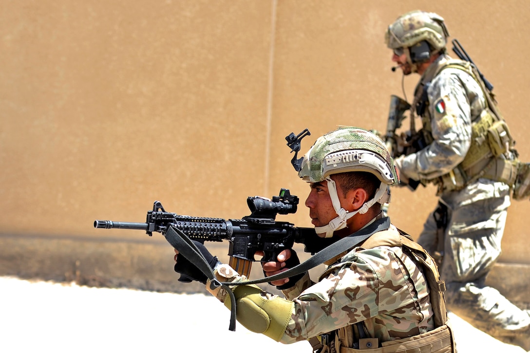 A Jordanian Special Forces troop and an Italian Special Operations Wing member advance to a helicopter extraction point during an interoperability combat search-and-rescue training exercise at the King Abdullah II Special Operations Training Center as part of Eager Lion 2017 in Amman, Jordan, May 11, 2017. Navy photo by Petty Officer 1st Class Matthew Cole 