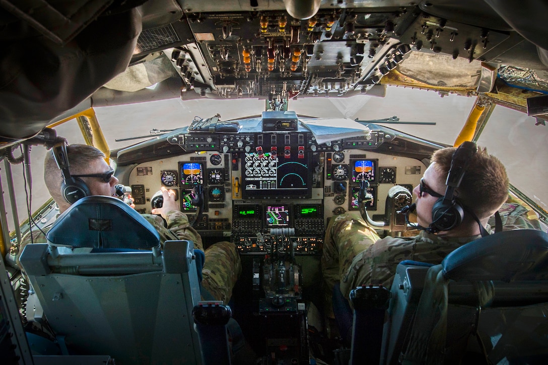 Air Force pilots perform in-flight checklists inside the cockpit of a KC-135 Stratotanker during a flight in support of Operation Inherent Resolve May 9, 2017. Air Force photo by Staff Sgt. Michael Battles
