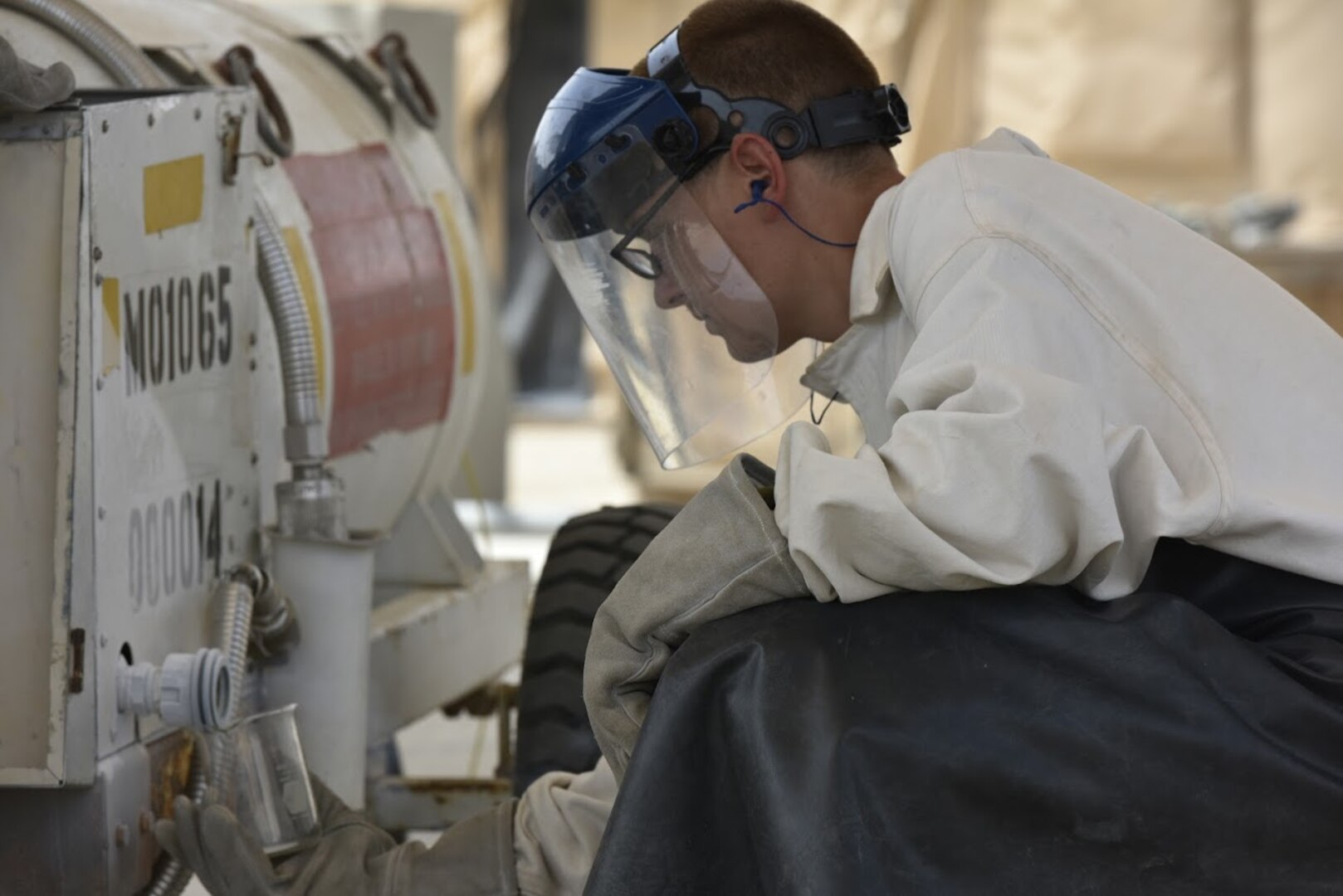 Airman 1st Class Jordan Mann, 407th Expeditionary Logistic Readiness Squadron petroleum, oil and lubricants flight fuel technician, gathers a sample of liquid oxygen after filling a portable tank May 10, 2017, in Southwest Asia. Fuel technicians maintain all POL substances, from diesel and gasoline to jet fuel and liquid oxygen. These materials play a vital role in delivering airpower to the fight against ISIS. The team here at the 407th Air Expeditionary Group supplies U.S. Marine Corps and coalition aircraft. (U.S. Air Force photo by Senior Airman Ramon A. Adelan)