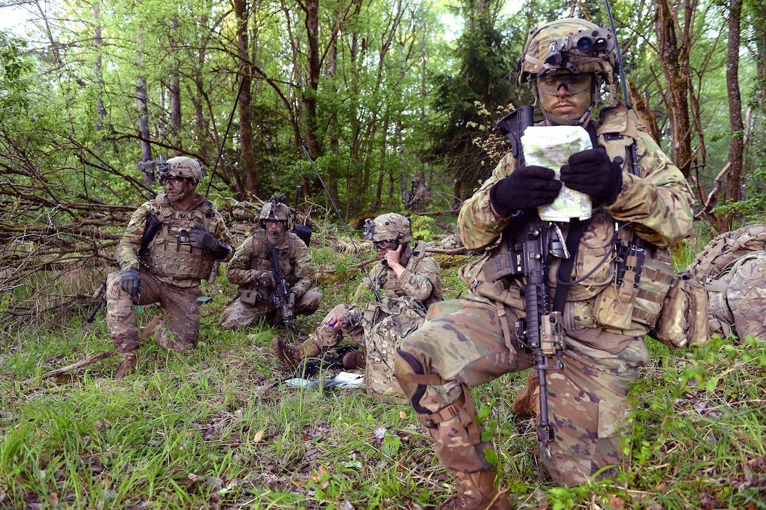 Soldiers report their location in the woods near a mock village during a field training exercise as of Saber Junction 17 at the Joint Multinational Readiness Center, Hohenfels, Germany, May 15, 2017. Army photo by Staff Sgt. Richard Frost
