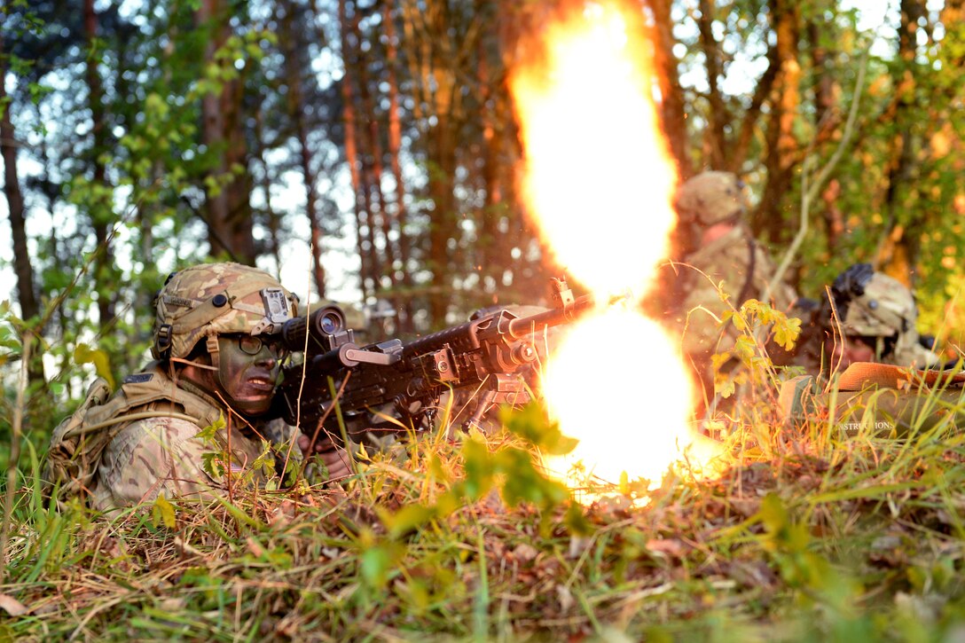 A soldier lays down covering fire with his M240 automatic weapon as his comrades maneuver near a small mock village during a field training exercise as part of Saber Junction 17 at the Joint Multinational Readiness Center, Hohenfels, Germany, May 15, 2017. Army photo by Staff Sgt. Richard Frost