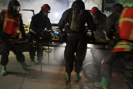 U.S. Army Reserve Soldiers from Madison, Wisconsin, based 409th Area Support Medical Company and 414th Chemical Company based in Orangeburg, South Carolina, work together to complete a mass casualty decontamination exercise May 8, 2017 at Muscatatuck Urban Training Center, Indiana. Nearly 4,100 Soldiers from across the country are participating in Guardian Response 17, a multi-component training exercise to validate U.S. Army units' ability to support the Defense Support of Civil Authorities (DSCA) in the event of a Chemical, Biological, Radiological, and Nuclear (CBRN) catastrophe. (U.S. Army Reserve photo by Sgt. Crystal Milton)