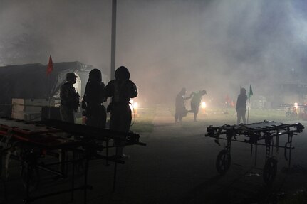 U.S. Army Reserve Soldiers from Madison, Wisconsin, based 409th Area Support Medical Company and 414th Chemical Company based in Orangeburg, South Carolina, work together to complete a mass casualty decontamination exercise May 8, 2017 at Muscatatuck Urban Training Center, Indiana. Nearly 4,100 Soldiers from across the country are participating in Guardian Response 17, a multi-component training exercise to validate U.S. Army units' ability to support the Defense Support of Civil Authorities (DSCA) in the event of a Chemical, Biological, Radiological, and Nuclear (CBRN) catastrophe. (U.S. Army Reserve photo by Sgt. Crystal Milton)