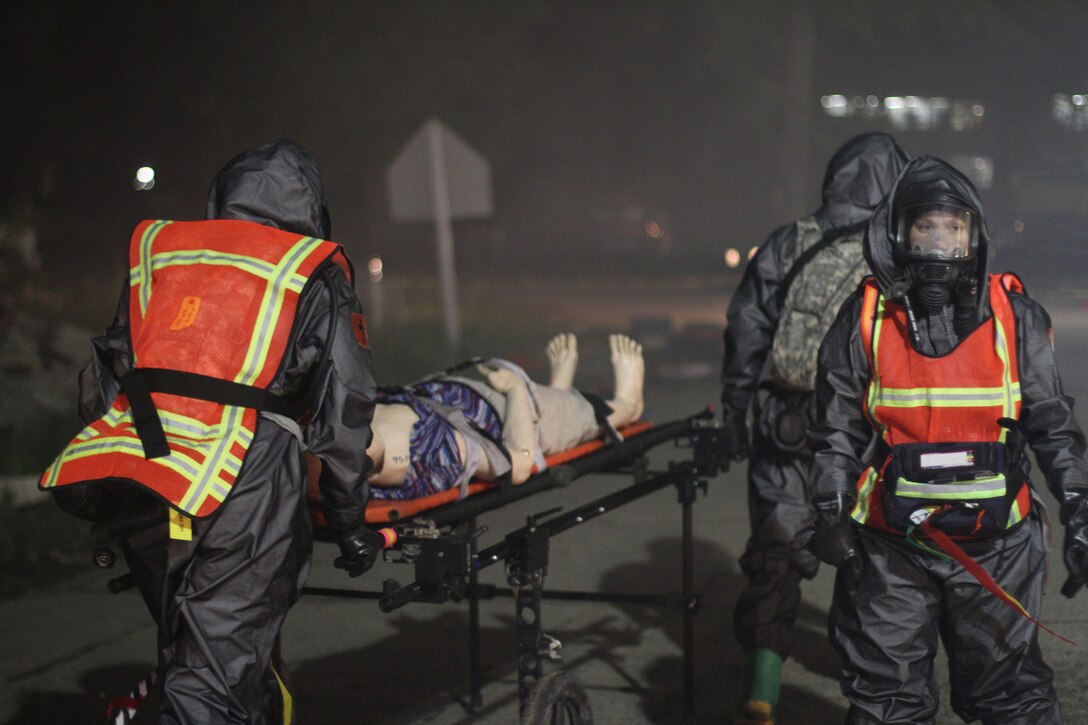 U.S. Army Reserve Soldiers from Madison, Wisconsin, based 409th Area Support Medical Company and 414th Chemical Company based in Orangeburg, South Carolina, work together to complete a mass casualty decontamination exercise May 8, 2017 at Muscatatuck Urban Training Center, Indiana. Nearly 4,100 Soldiers from across the country are participating in Guardian Response 17, a multi-component training exercise to validate U.S. Army units' ability to support the Defense Support of Civil Authorities (DSCA) in the event of a Chemical, Biological, Radiological, and Nuclear (CBRN) catastrophe. (U.S. Army Reserve photo by Sgt. Crystal Milton)