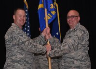 Maj. Joseph Edington, right, accepts command of the 341st Munitions Squadron from Col. Kenneth Speidel, 341st Maintenance Group commander, during an assumption of command ceremony May 12, 2017, at the auditorium at Malmstrom Air Force Base, Mont. (U.S. Air Force photo/Senior Airman Jaeda Tookes)