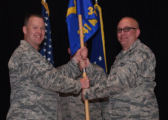 Maj. Joseph Edington, right, accepts command of the 341st Munitions Squadron from Col. Kenneth Speidel, 341st Maintenance Group commander, during an assumption of command ceremony May 12, 2017, at the auditorium at Malmstrom Air Force Base, Mont. (U.S. Air Force photo/Senior Airman Jaeda Tookes)