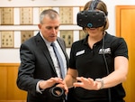 Department of Defense's 2017 Executive Leadership Development Program participant Amanda McGlone (right) experiences virtual reality simulations during the group's visit to 25th Air Force Headquarters at Joint Base San
Antonio-Lackland, Texas May 9. 