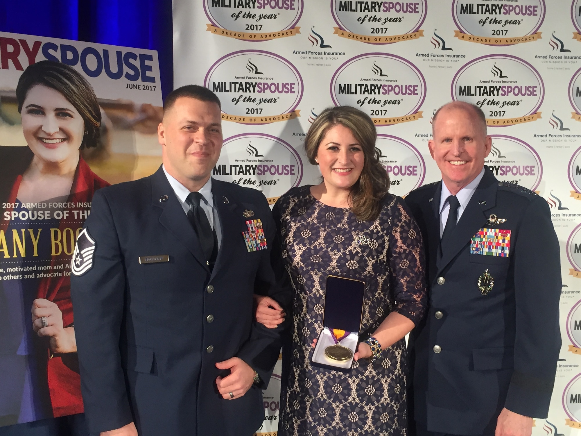 Mrs. Brittany Boccher is flanked by husband Master Sgt. (Special Agent) Adam Boccher of Air Force Office of Special investigations Detachment 327, Little Rock Air Force Base, Ark., and Gen. Stephen W. Wilson, Air Force Vice Chief of Staff, after she received the 2017 Armed Forces Insurance Military Spouse of the Year Award May 12, at the U.S, Chamber of Commerce in Washington, D.C. (Photo by Suzanne Trevino/Gordon C. James Public Relations)  
