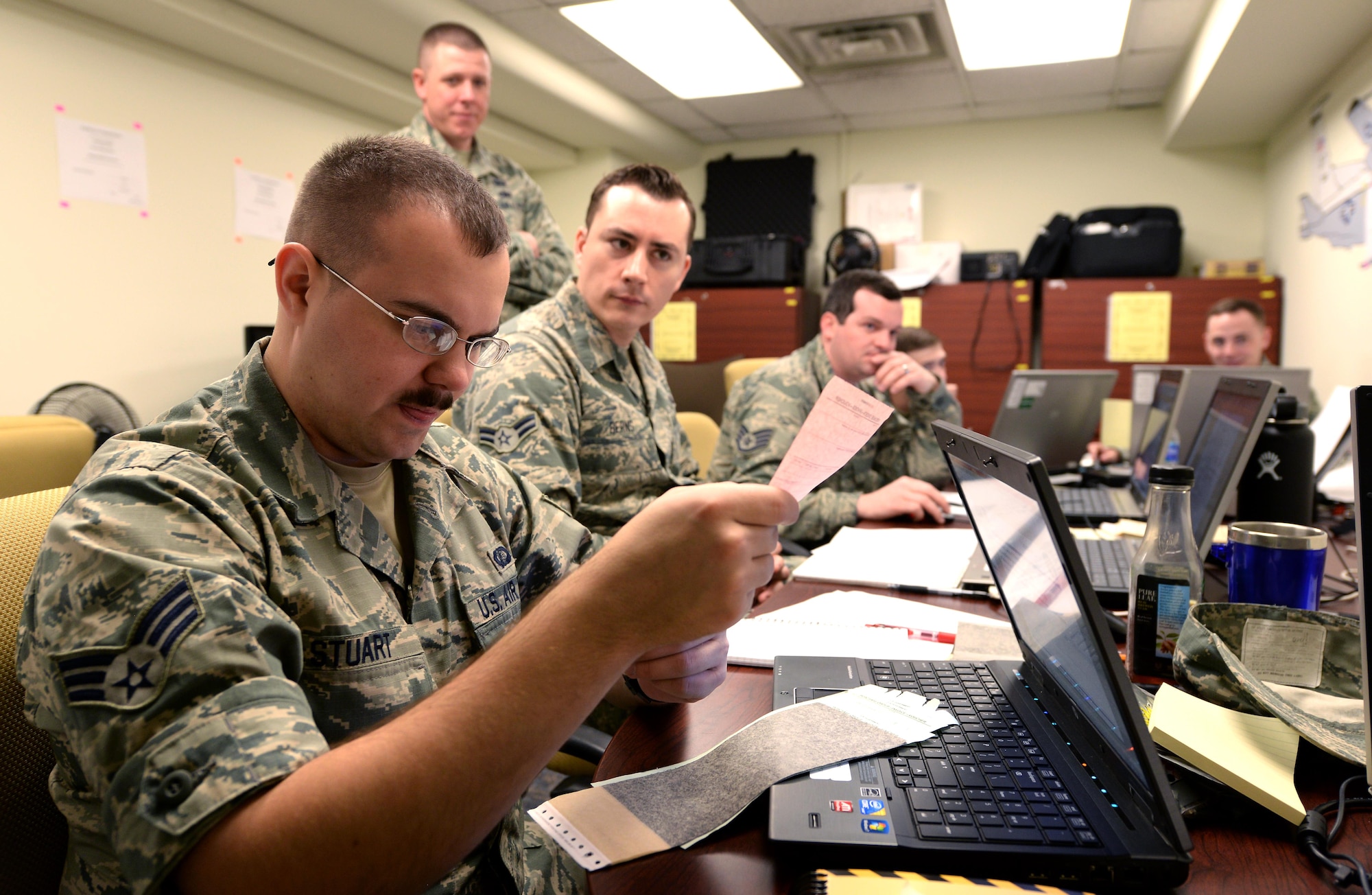 Senior Airman Jeffrey Stuart, 55th Contracting Squadron contract specialist, looks over an invoice while resolving a simulated payment discrepancy as part of a scenario during a contingency contracting exercise May 10, 2017 at Offutt Air Force Base, Neb. The exercise lasted five days from May 8 – 12 and was designed to improve contracting readiness for bare base operations. (U.S. Air Force photo by Delanie Stafford)