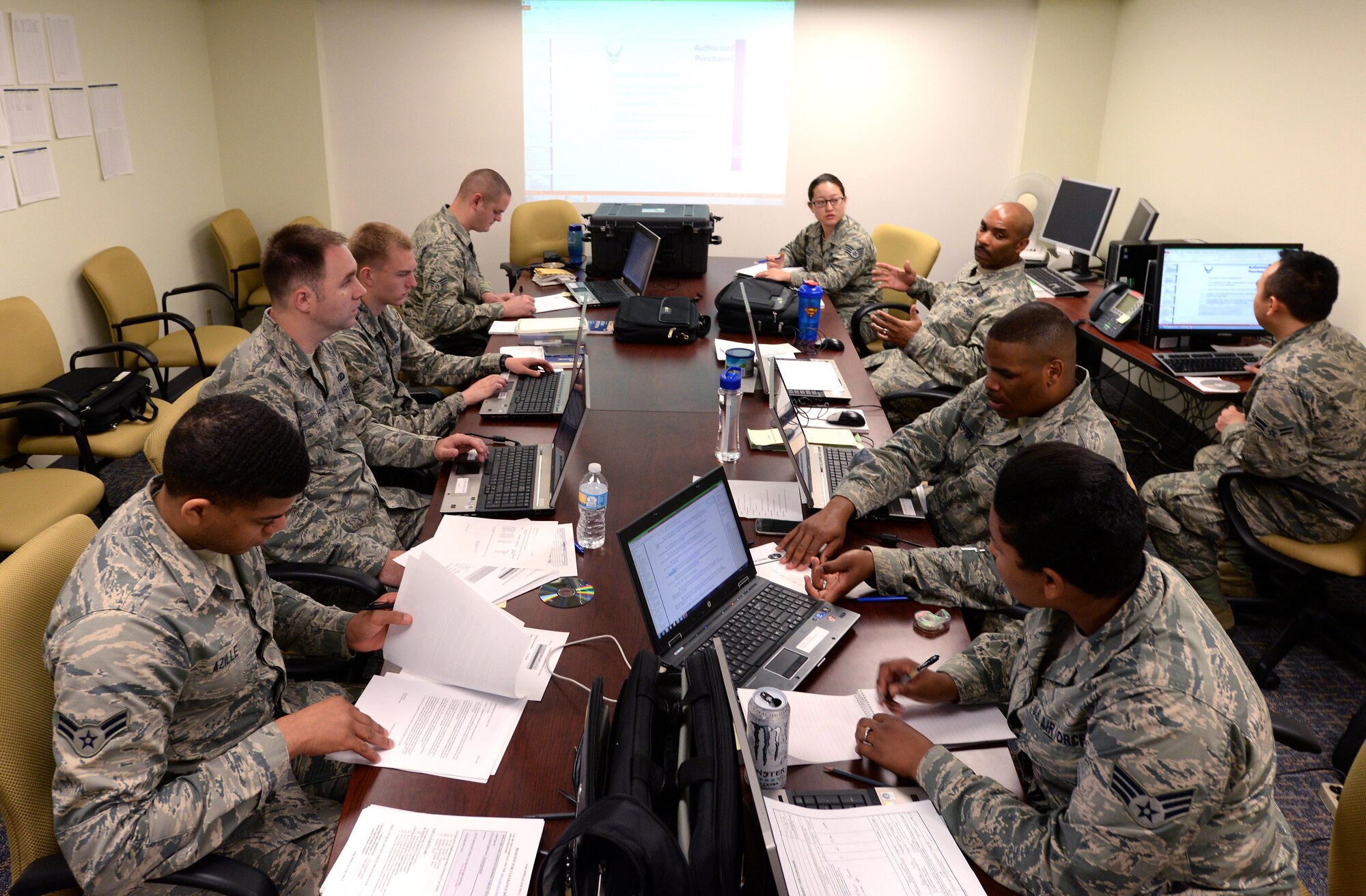 A team of contract specialists and contract officers from the 55th Contracting Squadron discuss learning objectives that were used in various scenarios during a contingency contracting exercise held at Offutt Air Force Base, Neb. May 8 – 12. The exercise was designed to improve contracting readiness for bare base operations. (U.S. Air Force photo by Delanie Stafford)