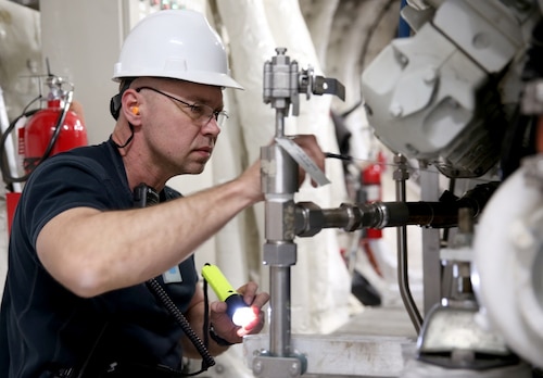 Sergey Amosov, USNS Trenton second engineer, inspects engine components during a routine maintenance check in Marseilles, France, April 5, 2017. Trenton, one of only eight expeditionary fast transport ships in the Military Sealift Command’s inventory, recently completed an annual dry-dock overhaul in Marseilles. Military Sealift Command-Europe photo by Matthew Montgomery