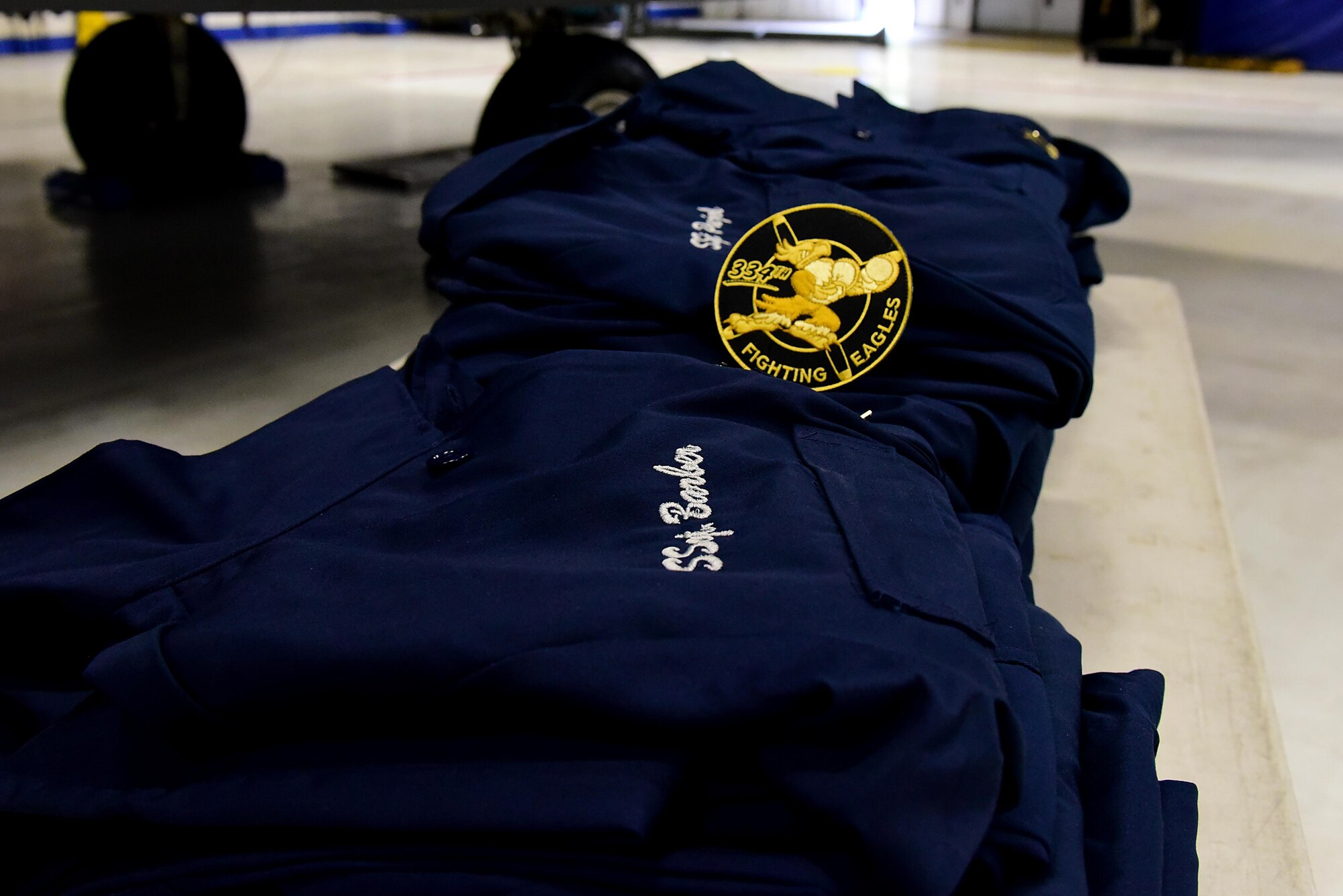 During a Dedicated Crew Chief ceremony, each new DCC received custom-made overalls embroidered with their aircraft’s tail number and their name and rank, May 2, 2017, at Seymour Johnson Air Force Base, North Carolina. The DCCs also received custom 334th Fighting Eagles patches, which incorporates the heritage of the 334th Eagle Squadron dating back to World War II. (U.S. Air Force photo by Airman 1st Class Kenneth Boyton)