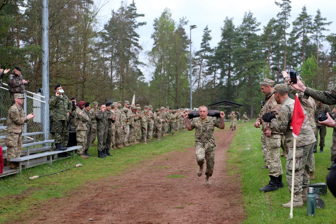 Ukrainian soldiers compete against other nations in a relay race with tank-related objects while Army soldiers cheer them on in Grafenwoehr, Germany, May 12, 2017. Army photo by Staff Sgt. Kathleen V. Polanco