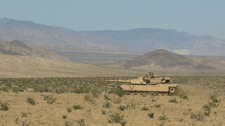 Marines with 1st Tank Battalion traverse terrain in an M1A1 Abrams Main Battle Tank during a movement to contact drill with Marines from 3rd Assault Amphibious Battalion and 2nd Battalion, 4th Marine Regiment aboard Marine Corps Air Ground Combat Center, Twentynine Palms, Calif., May 4, 2017. Marine Corps Operational Test and Evaluation Activity Office conducted the exercise as part of operational testing used to compare an upgraded AAV to its old variant. (U.S. Marine Corps photo by Cpl. Dave Flores)