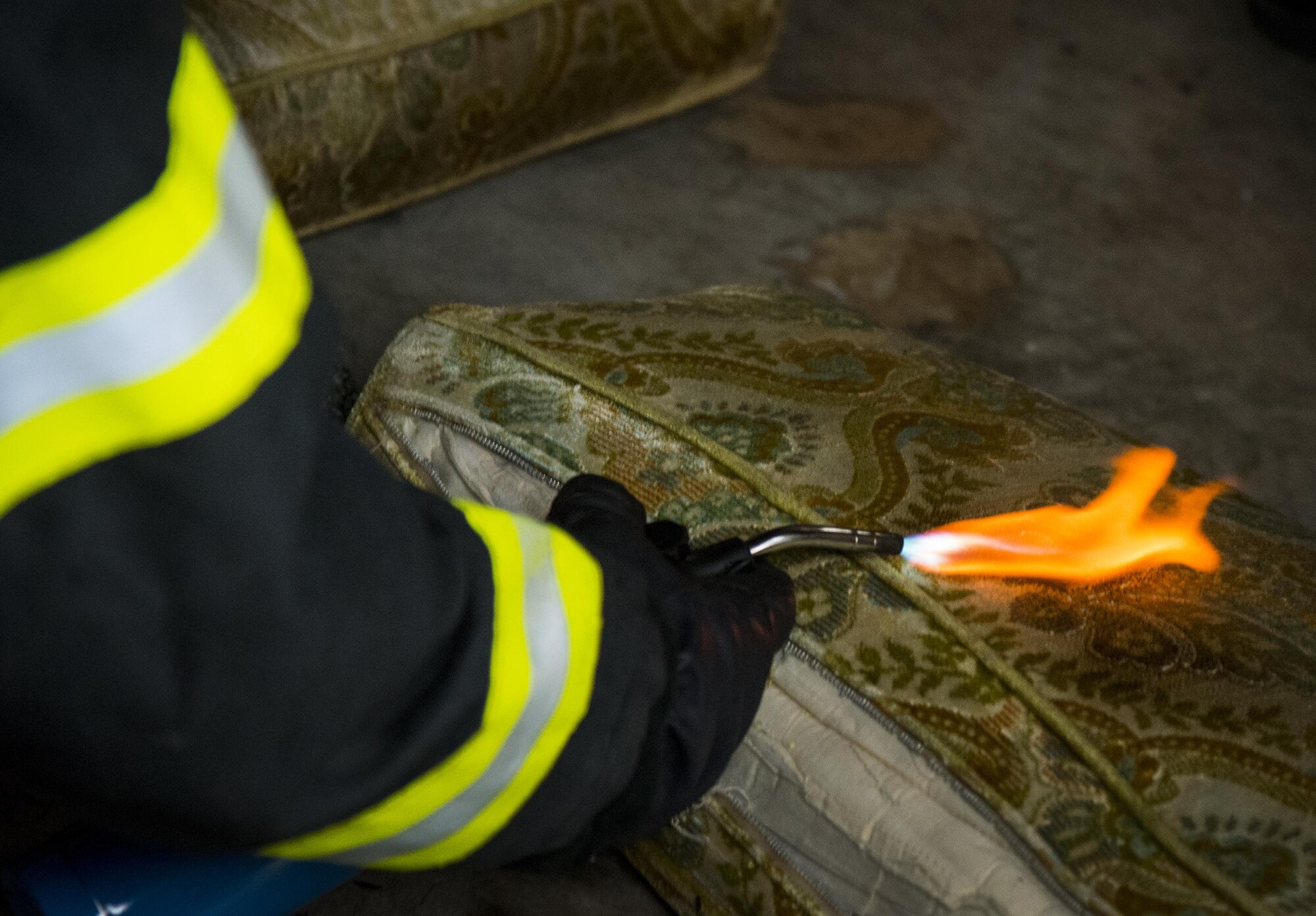 Instructor, Jason Krusen, sets fire to a couch cushion to demonstrate the contaminants within the smoke it emits during a “Know Your Smoke” training course held May 12 in Niceville Fla.  More than 10 local fire and rescue agencies attended the lecture and hands-on training including Airmen from Hurlburt Field, Eglin and Tyndall Air Force Bases.  The goal of the course was to highlight the dangers associated with the types of chemicals emitted within smoke during residential and commercial facility fires and how that toxicity has increased over the years.  (U.S. Air Force photo/Samuel King Jr.)