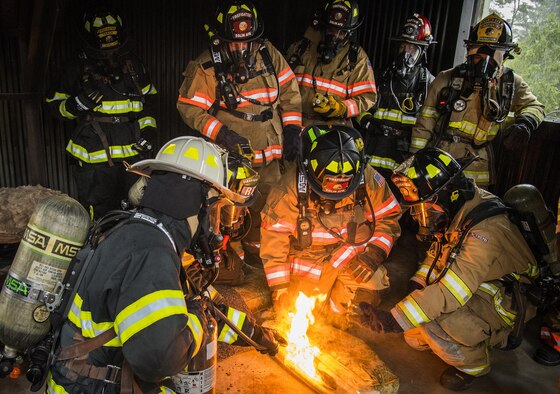 Firefighters use detection devices to examine the contaminants in the smoke emitted from a burning couch cushion during a “Know Your Smoke” training course held May 12 in Niceville Fla.  More than 10 local fire and rescue agencies attended the lecture and hands-on training including Airmen from Hurlburt Field, Eglin and Tyndall Air Force Bases.  The goal of the course was to highlight the dangers associated with the types of chemicals emitted within smoke during residential and commercial facility fires and how that toxicity has increased over the years.  (U.S. Air Force photo/Samuel King Jr.)