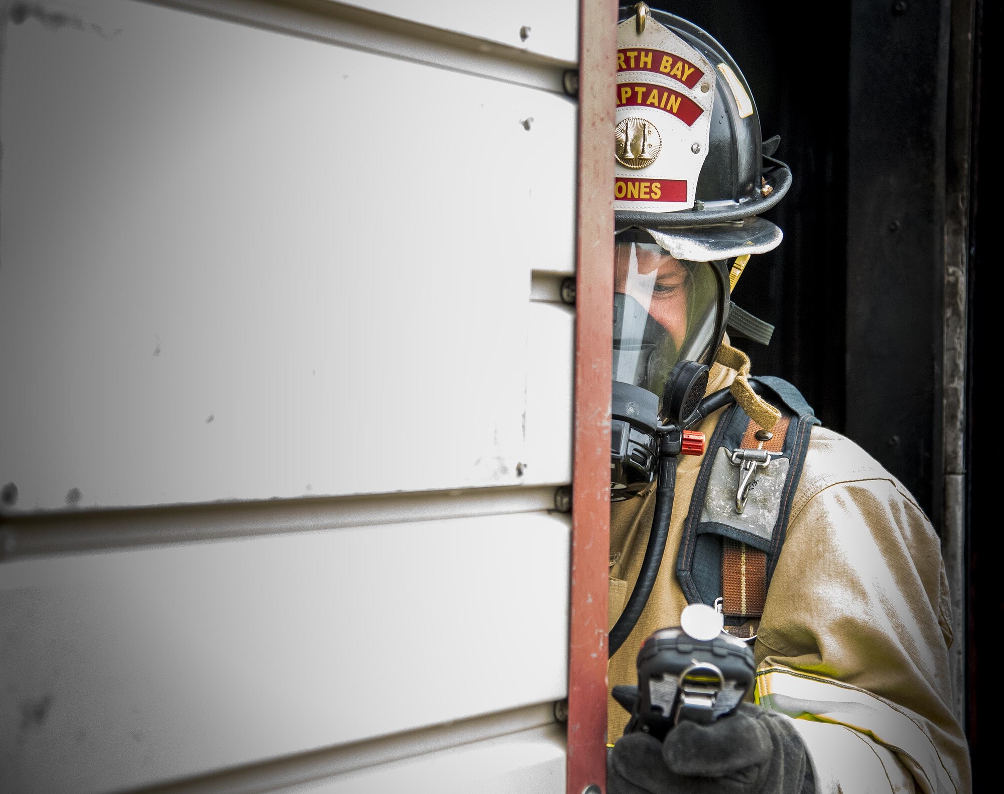 A North Bay firefighter clears his contaminant detection device in the fresh air during a “Know Your Smoke” training course held May 12 in Niceville Fla.  More than 10 local fire and rescue agencies attended the lecture and hands-on training including Airmen from Hurlburt Field, Eglin and Tyndall Air Force Bases.  The goal of the course was to highlight the dangers associated with the types of chemicals emitted within smoke during residential and commercial facility fires and how that toxicity has increased over the years.  (U.S. Air Force photo/Samuel King Jr.)