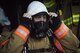 A firefighter puts on his protective equipment prior to a live burn during a “Know Your Smoke” training course held May 12 in Niceville Fla.  More than 10 local fire and rescue agencies attended the lecture and hands-on training including Airmen from Hurlburt Field, Eglin and Tyndall Air Force Bases.  The goal of the course was to highlight the dangers associated with the types of chemicals emitted within smoke during residential and commercial facility fires and how that toxicity has increased over the years.  (U.S. Air Force photo/Samuel King Jr.)