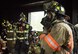 Firefighters put on their protective equipment prior to a live burn during a “Know Your Smoke” training course held May 12 in Niceville Fla.  More than 10 local fire and rescue agencies attended the lecture and hands-on training including Airmen from Hurlburt Field, Eglin and Tyndall Air Force Bases.  The goal of the course was to highlight the dangers associated with the types of chemicals emitted within smoke during residential and commercial facility fires and how that toxicity has increased over the years.  (U.S. Air Force photo/Samuel King Jr.)