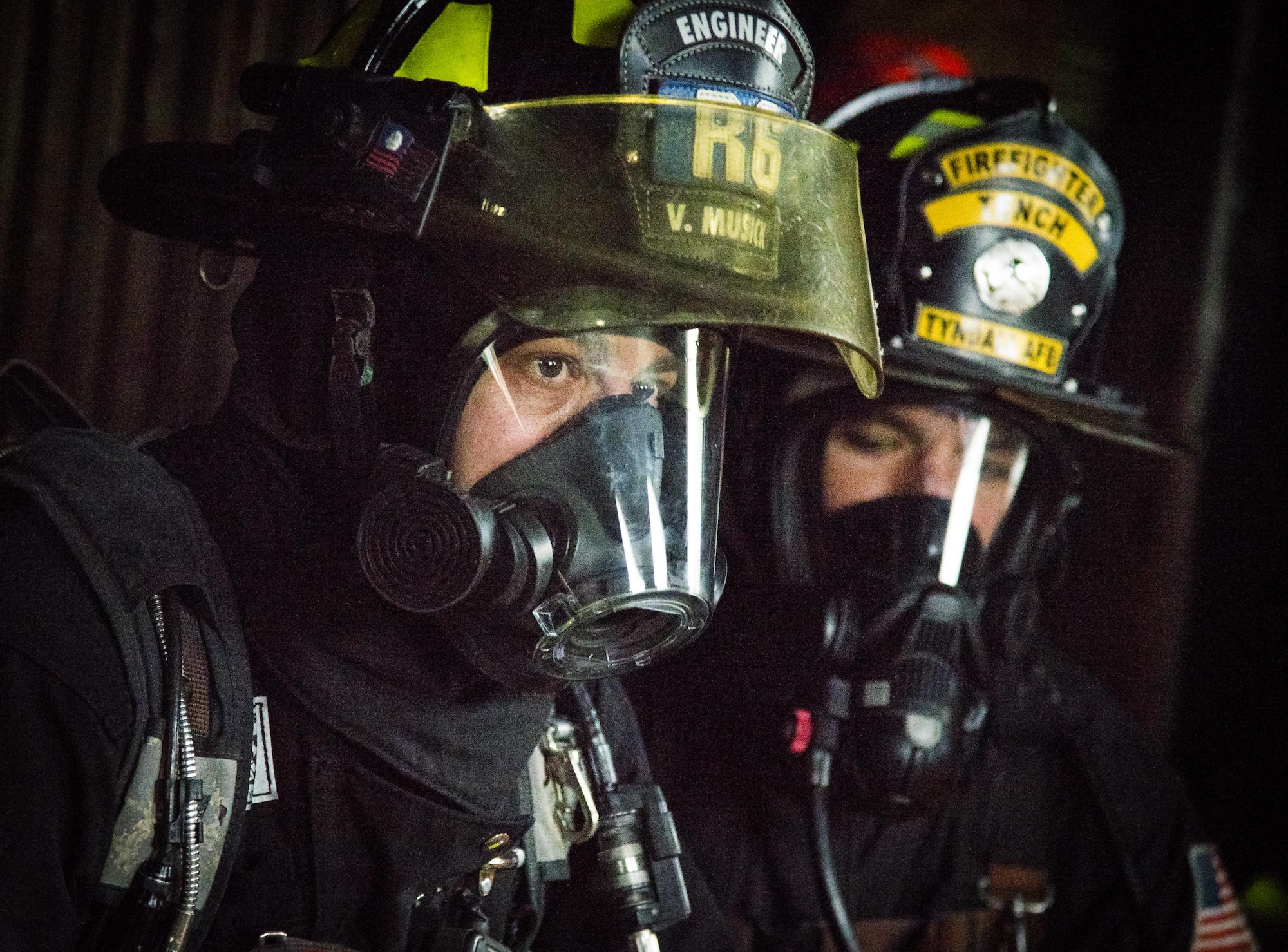 Firefighters wait to begin a live burn exercise during a “Know Your Smoke” training course held May 12 in Niceville Fla.  More than 10 local fire and rescue agencies attended the lecture and hands-on training including Airmen from Hurlburt Field, Eglin and Tyndall Air Force Bases.  The goal of the course was to highlight the dangers associated with the types of chemicals emitted within smoke during residential and commercial facility fires and how that toxicity has increased over the years.  (U.S. Air Force photo/Samuel King Jr.)
