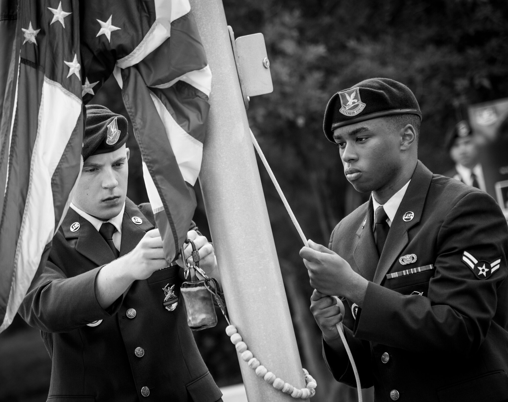 Airmen 1st Class Michael Garayalde and Tiras Harris,96th Security Forces Squadron, prepare to raise the flag at the opening ceremony of Police Week at Eglin Air Force Base, Fla., May 15.  The ceremony was a gathering of security forces personnel for a formation and reveille ceremony performed at the All Wars Memorial.  Police Week activities will happen throughout the week and will close with security forces Airmen performing a retreat ceremony at Bldg. 1.  (U.S. Air Force photo/Samuel King Jr.)