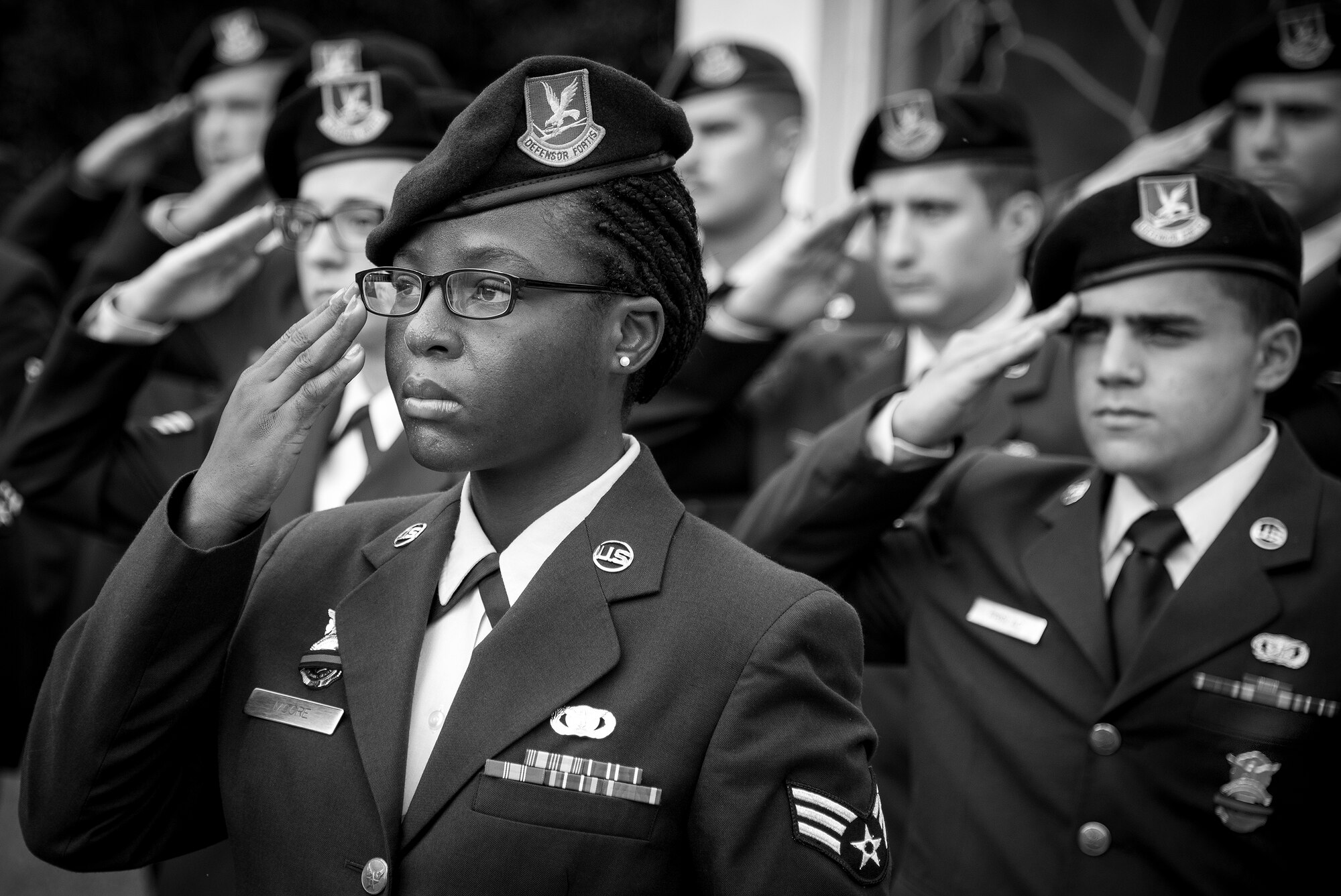Senior Airman Delise Moore, 96th Security Forces Squadron, salutes with other Airmen in formation during the opening ceremony of Police Week at Eglin Air Force Base, Fla., May 15.  The ceremony was a gathering of security forces personnel for a formation and reveille ceremony performed at the All Wars Memorial.  Police Week activities will happen throughout the week and will close with security forces Airmen performing a retreat ceremony at Bldg. 1.  (U.S. Air Force photo/Samuel King Jr.)