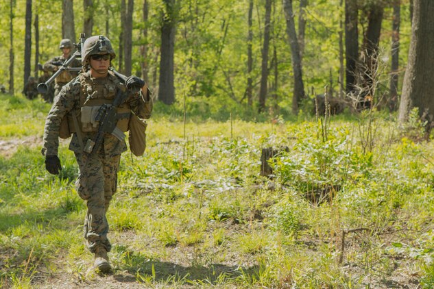 A Marine carries a machine gun tripod on a patrol during a company attack exercise at Fort A.P. Hill, Va., May 1, 2017. The Marines conducted a live-fire exercise that helped improve their leadership and teamwork abilities. The Marines are with G Company, 2nd Battalion, 2nd Marine Regiment. (U.S. Marine Corps photo by Pfc. Abrey D. Liggins)