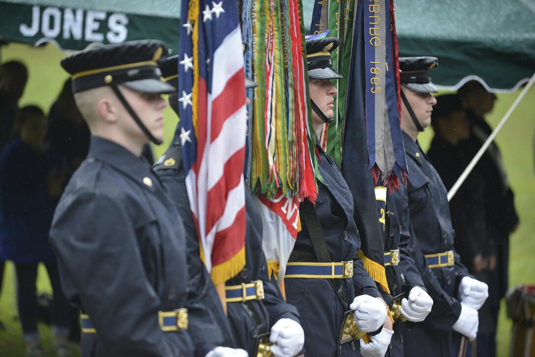 Soldiers from the 3rd United States Infantry Regiment, the Old Guard, present the colors during a reinterment May 12, 2017 for Private Samuel Howard, Revolutionary War soldier, at Resthaven Cemetery in Baxter, Ky. 