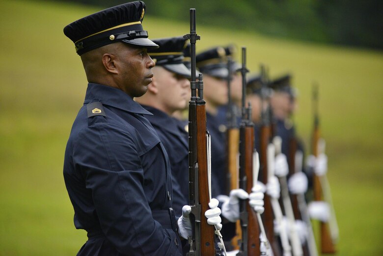 Staff Sgt. Earl Thomas and soldiers from the 3rd United States Infantry Regiment, the Old Guard, stand at attention before shooting the first volley of a 21-gun salute during a reinterment ceremony May 12, 2017 for Private Samuel Howard, Revolutionary War soldier, at Resthaven Cemetery in Baxter, Ky. 