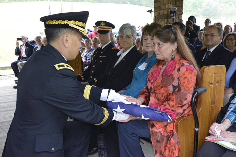 Brig. Gen. Mark Toy, U.S. Army Corps of Engineers Great Lakes and Ohio River Division commander, presents the U.S. Flag to Sharon Osborne, descendant of Revolutionary War Private Samuel Howard, during his reinterment May 12, 2017 at Resthaven Cemetery in Baxter, Ky.